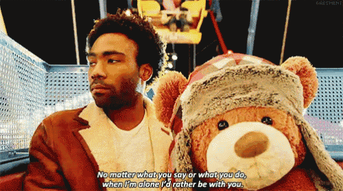 a man sitting next to a teddy bear that says no matter what