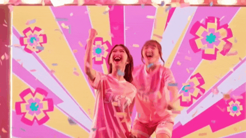 two women are standing next to each other in front of a pink and yellow background with confetti falling around them .