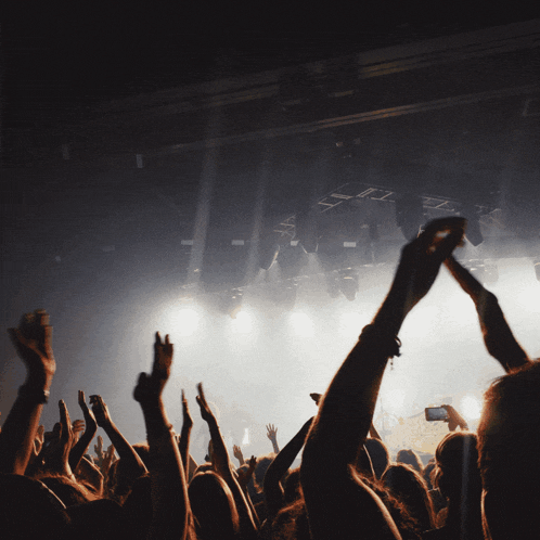 a crowd of people at a concert with the words welcome to nyanyi bareng above them