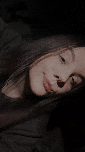 a close up of a woman 's face with a shadow on her face