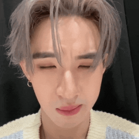 a close up of a young man with his eyes closed