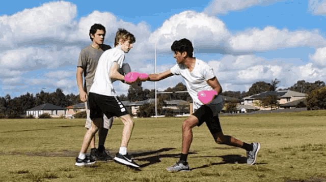 a group of young men are playing a game of frisbee in a grassy field