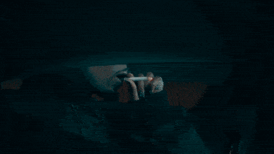 a blurry picture of a man looking out a window at night