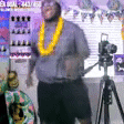 a man is standing in front of a camera on a tripod .