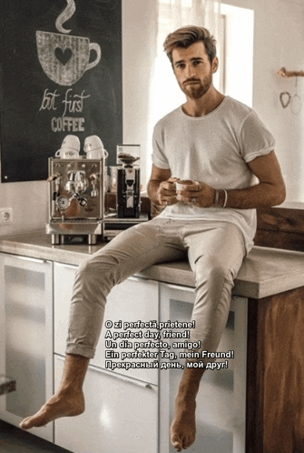 a man sits on a counter in front of a sign that says " let 's first coffee "