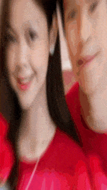 a blurry picture of a man and a woman in red