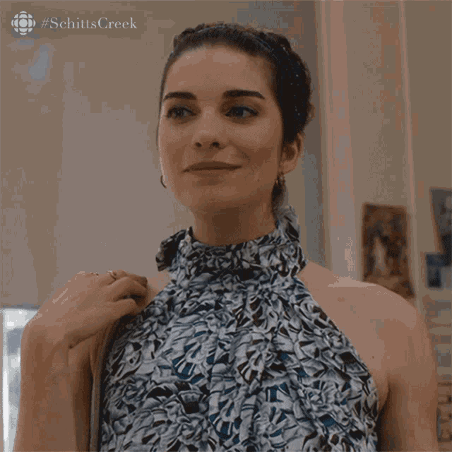 a woman is wearing a blue and white dress with the word sure above her