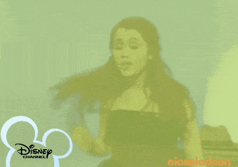 a boy is sitting at a table with a disney channel logo behind him
