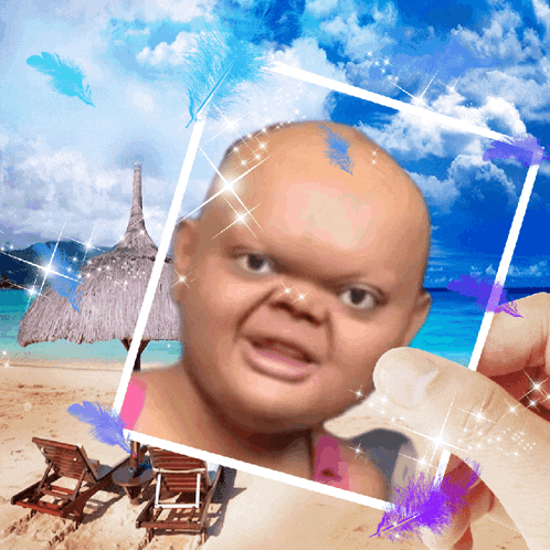a person is holding a picture of a baby with a beach in the background