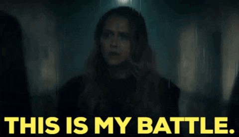 a woman with long hair is standing in a dark hallway with the words this is my battle .