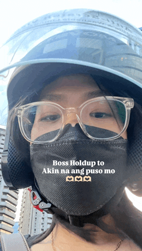 a woman wearing a mask and a helmet says boss hold up to akin na ang puso mo