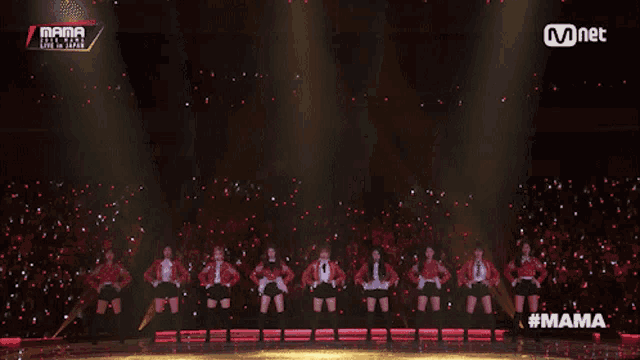 a group of women are dancing on a stage with the words mama on the bottom