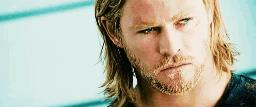 a close up of a man 's face with a beard