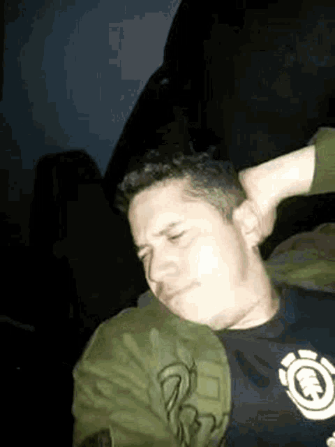 a man is laying on a couch with his head on another man 's lap .