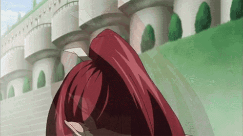 a cartoon character with red hair is standing in front of a castle .