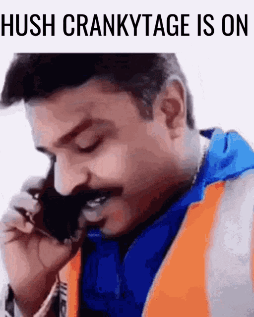 a man with a mustache is talking on a cell phone with the words hush crankytage is on above him
