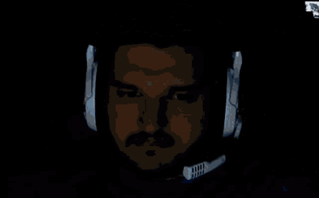 a man with a beard wearing headphones with a microphone