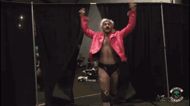 a man in a pink jacket with the name effy on a sign