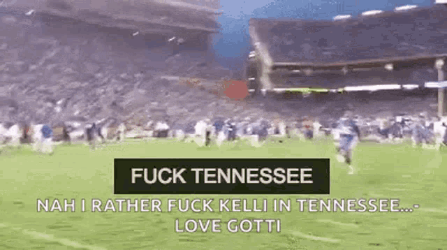 a football game is being played in a stadium with a sign that says `` fuck tennessee ''