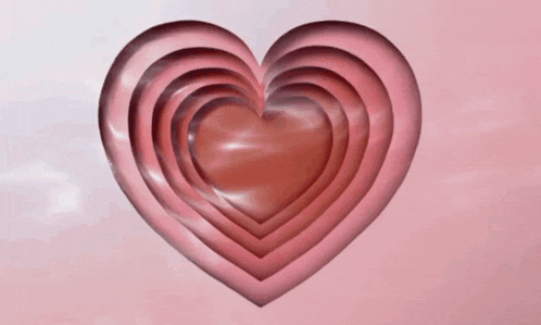 a stack of hearts on a pink surface