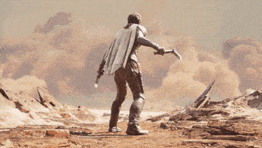 a man in a cape is holding a gun in a desert landscape