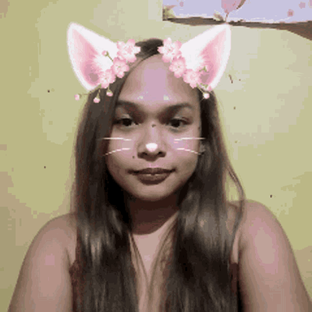 a woman is wearing a cat mask with flowers on her face