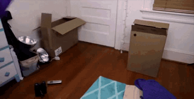 a cardboard box with a hole in the middle of it sits on the floor