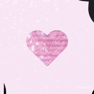a pink heart with a black hole in the middle is surrounded by a black background