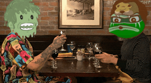 two people sitting at a table with glasses of wine and a picture on the wall that says #fight