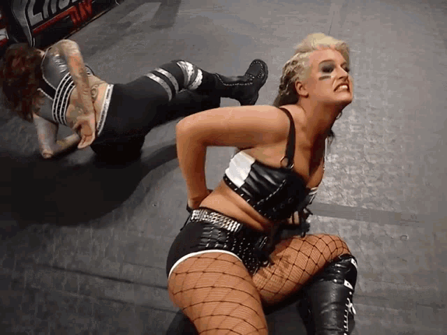 two women are wrestling in a ring with a sign in the background that says ' ncw '