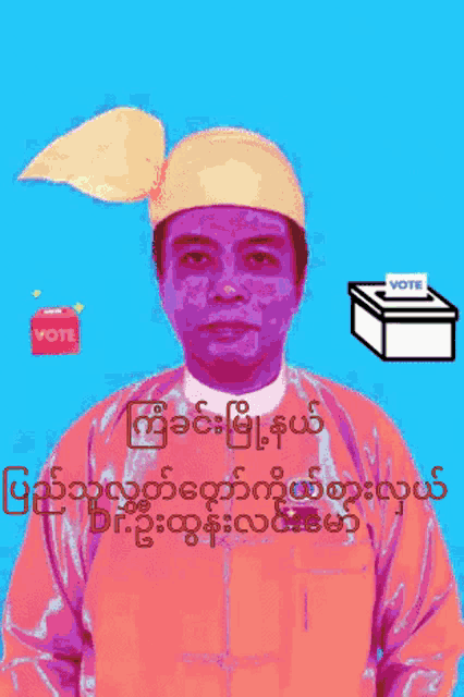 a man wearing a yellow hat is standing next to a vote box