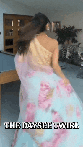 a woman in a floral dress is dancing in a room with the words the daysee twirl above her