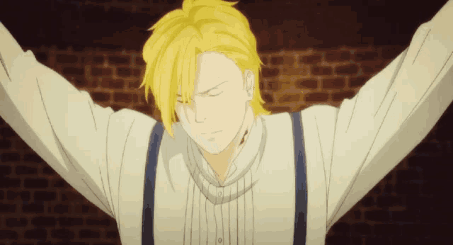 a man with yellow hair and suspenders is standing in front of a brick wall with his arms outstretched