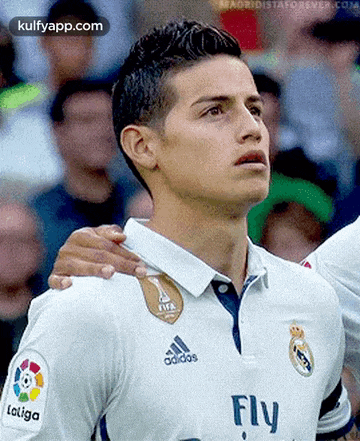 a close up of a soccer player wearing an adidas fly shirt
