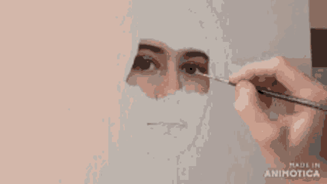 a woman is painting a picture of her face with a brush .