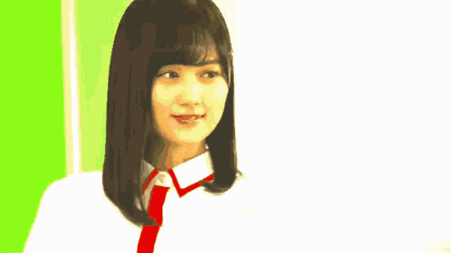 a woman in a white shirt and red tie is making a thumbs up sign