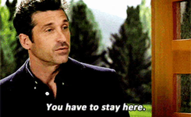 a man says " you have to stay here " while standing in front of a door