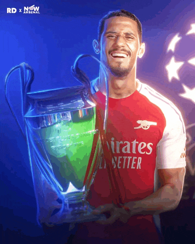 a man holding a trophy that says emirates better