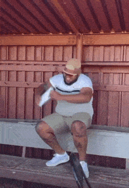 a man sitting on a bench with a tattoo on his leg that says ' chicago '