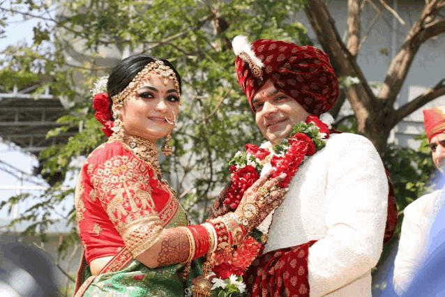 a bride and groom are posing for a picture in their wedding outfits