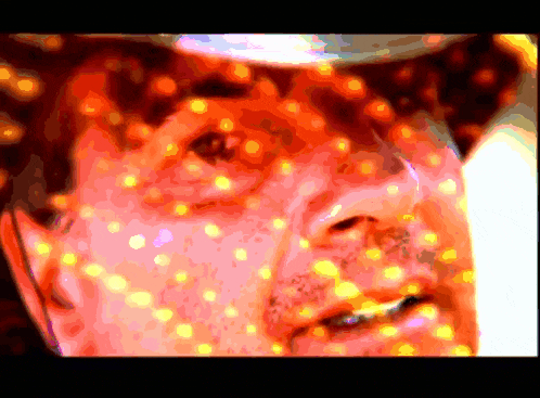 a close up of a man 's face with a lot of lights on his face