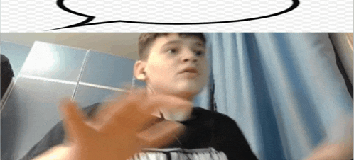 a young boy is making a funny face while wearing headphones and a speech bubble .