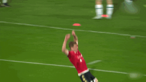 a soccer player in a red jersey with the word united on the front