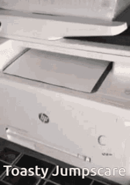 a white hp printer is sitting on a table