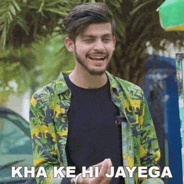 a man wearing a colorful shirt says " kha ke hi jayega " in a foreign language