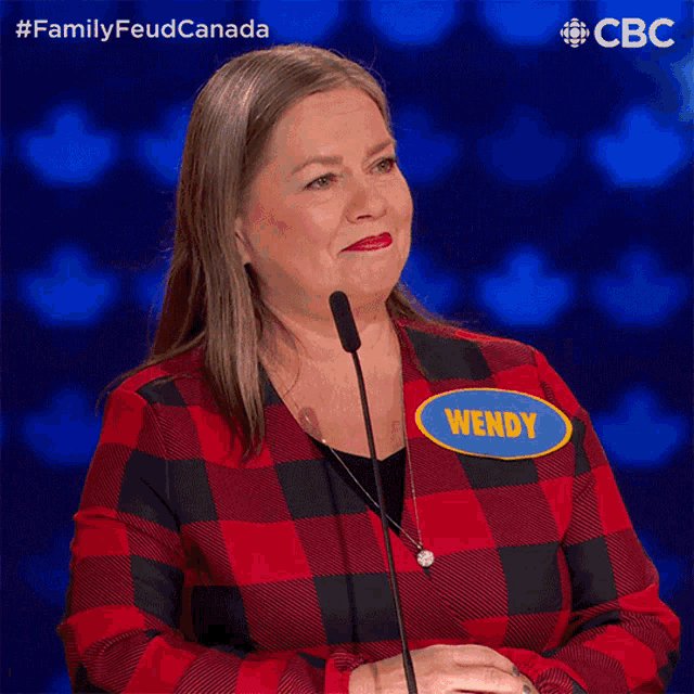 a woman in a red plaid shirt has a name tag that says wendy