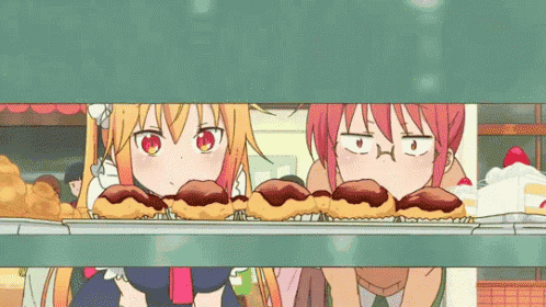 two anime girls are looking at a tray of doughnuts