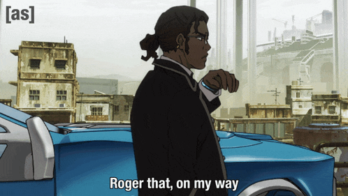 a man in a suit stands in front of a blue car with the words roger that on my way above him