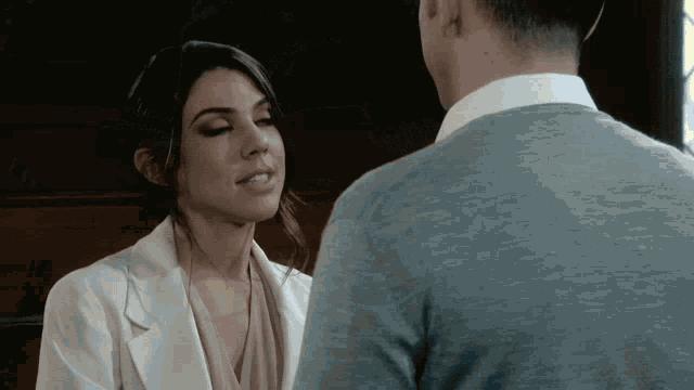 a man and a woman are looking at each other