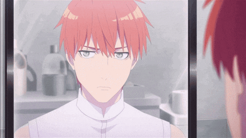 a man with red hair looking at himself in a mirror